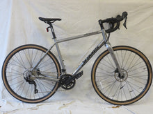 Load image into Gallery viewer, A Jamis Renegade S3 gravel bicycle with steel frame and components, featuring a chain drive and brakes, positioned against a white background.
